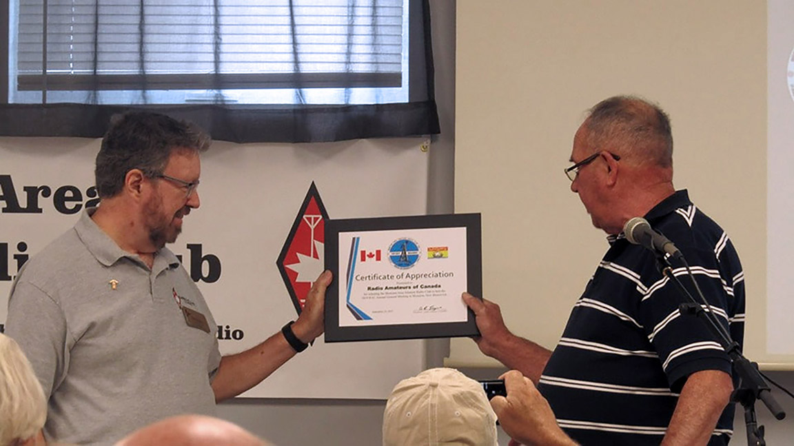 Glenn MacDonell, VE3XRA (RAC President) accepts Certificate of Appreciation from André Goguen, VE9ARG (Moncton Area ARC President) at the RAC Annual General Meeting in Moncton.
